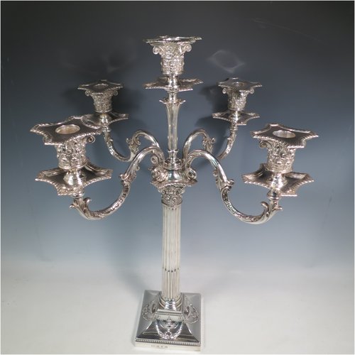 An Antique Victorian Sterling Silver single five-light candelabrum in a Corinthian style having Neoclassical hand-chased decoration, sitting on a square base, a fluted column with acanthus leaf style arms and capitals, removable nozzles with drip pans, and gadroon edge borders. Made by Elkington & Co., of Birmingham in 1895. The dimensions of this fine hand-made antique silver candelabrum are height 52 cms (20.5 inches), and spread across arms 38 cms (15 inches). Please note that this item can be converted into a three-light candelabrum.