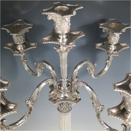 An Antique Victorian Sterling Silver single five-light candelabrum in a Corinthian style having Neoclassical hand-chased decoration, sitting on a square base, a fluted column with acanthus leaf style arms and capitals, removable nozzles with drip pans, and gadroon edge borders. Made by Elkington & Co., of Birmingham in 1895. The dimensions of this fine hand-made antique silver candelabrum are height 52 cms (20.5 inches), and spread across arms 38 cms (15 inches). Please note that this item can be converted into a three-light candelabrum.