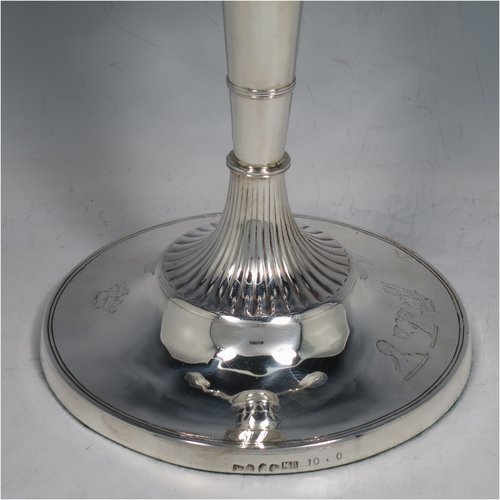 An Antique Georgian / Victorian Sterling Silver pair of candelabra in a Neoclassical style, having removable arms with three lights, fluted and reed-banded columns with round bases, cast scroll-shaped arms, capitals with reeded decoration, removable nozzles with drip pans, and reed-edged borders. The candelabra bases are made by Matthew Boulton of Birmingham in 1795, whilst the branches are made by James Garrard of London in 1883. The dimensions of this fine hand-made pair of silver candelabra are height 41.5 cms (16.3 inches), and spread across arms 31.5 cms (12.3 inches). Please note that these are crested on the bases and nozzles.