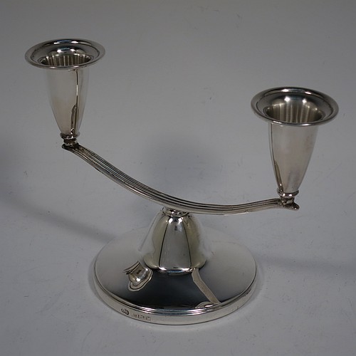 An unusual Sterling Silver pair of small two-light candelabra, having round bases with a cast reeded arms, with two attached plain round candle-holders. Made by Elkington and Co., of Birmingham in 1989. The dimensions of this fine hand-made pair of silver candelabra are height 11 cms (4.25 inches), and spread across arms 15 cms (6 inches).    