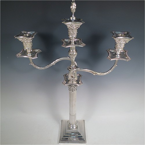 A very pretty Antique Victorian Sterling Silver single candelabrum, having three lights in a Corinthian style with a stepped square base, a fluted round column, double swirl acanthus leaf arms and capitals, removable nozzles with drip pans and central extinguisher with cast flame finial, and bead-edged borders. Made by Fordham and Faulkner of London in 1897. The dimensions of this fine hand-made antique silver single candelabrum are height 63.5 cms (25 inches), and spread across arms 38 cms (15 inches).    