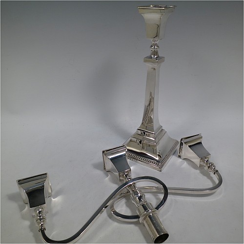 A very handsome Sterling Silver single Art Deco style candelabrum, having a square stepped base with an applied lower bead border, a plain panelled column with tapering sides, with double swirl reeded arms and matching capitals with removable nozzles. Made by Britton Gould and Co., of Birmingham in 1935. The dimensions of this fine hand-made silver Art Deco single candelabrum are height 41 cms (16.25 inches), spread across arms 33.5 cms (13.25 inches), and it weighs approx. 957g (31 troy ounces). Please note that this candelabrum is not filled, so the whole weight is silver.   