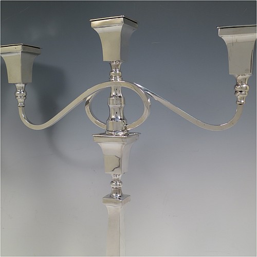 A very handsome Sterling Silver single Art Deco style candelabrum, having a square stepped base with an applied lower bead border, a plain panelled column with tapering sides, with double swirl reeded arms and matching capitals with removable nozzles. Made by Britton Gould and Co., of Birmingham in 1935. The dimensions of this fine hand-made silver Art Deco single candelabrum are height 41 cms (16.25 inches), spread across arms 33.5 cms (13.25 inches), and it weighs approx. 957g (31 troy ounces). Please note that this candelabrum is not filled, so the whole weight is silver.   