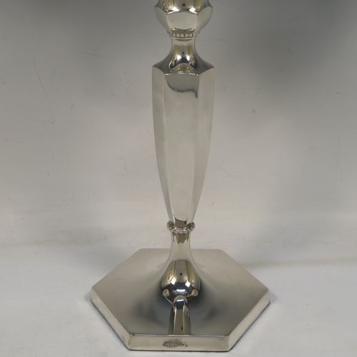 A very elegant pair of three-light Silver Plated Art Deco style candelabra, having plain hexagonal bases with an applied lower bead border, a plain panelled column with tapering sides, with removable swirl hexagonal cross-section arms, and matching capitals with removable nozzles and bead-edged borders. Made by Hawksworth and Eyre of Sheffield in ca. 1930. The dimensions of this fine hand-made pair silver-plated  Art Deco candelabra are height 40 cms (15.75 inches), and spread across arms 37 cms (14.5 inches).