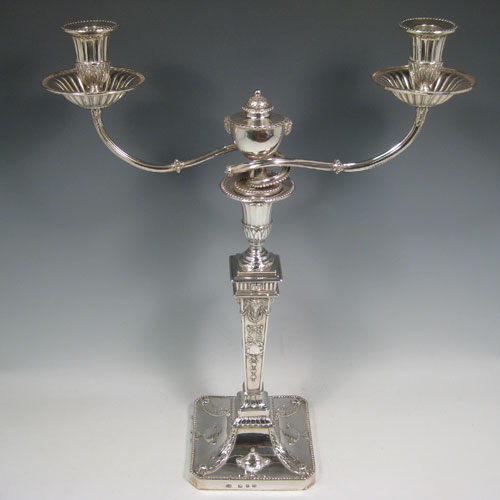    Antique Georgian sterling silver rare and fine pair of two-light candelabra made by John Steward of London in 1775. All hand-chased with Neoclassical style decoration including swags, rams heads, and tureens. Together with bead edges and fluted decoration on the nozzles. Height 45 cms (17.75 inches), width 35 cms (13.75 inches).