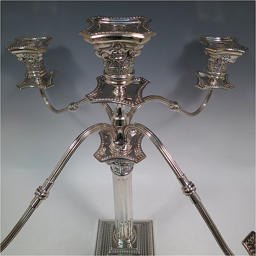 A Sterling Silver pair of large five-light Corinthian style candelabra, having fluted columns, acanthus-leaf capitals, stepped bases, bead-edge borders, and removable arms with drip pans and nozzles. Made by Britton Gould & Co., of Birmingham in 1930. The dimensions of this fine hand-made pair of candelabra are height 46 cms (18 inches), and spread across arms 51 cms (20 inches).