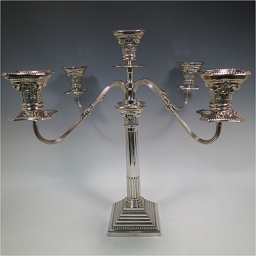 A Sterling Silver pair of large five-light Corinthian style candelabra, having fluted columns, acanthus-leaf capitals, stepped bases, bead-edge borders, and removable arms with drip pans and nozzles. Made by Britton Gould & Co., of Birmingham in 1930. The dimensions of this fine hand-made pair of candelabra are height 46 cms (18 inches), and spread across arms 51 cms (20 inches).