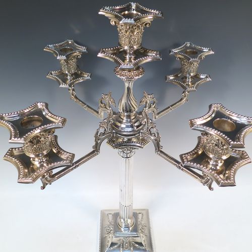 A very pretty and large pair of Antique Victorian Silver Plated five-light Corinthian style candelabra, having fluted columns, acanthus-leaf capitals, stepped bases, with bead-edge borders, and removable arms with drip pans and nozzles. Please note that these can be converted to a pair of three-light candelabra. Made by Hawksworth Eyre and Co. of Sheffield in ca. 1880. The dimensions of this fine hand-made pair of silverplated five-light candelabra are height 56 cms (22 inches), and spread across arms 39 cms (15.3 inches).   