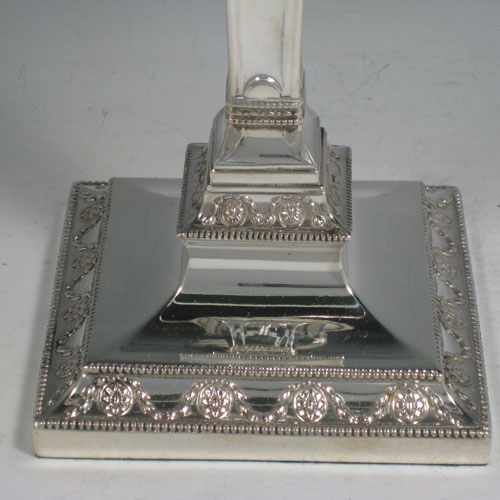    Antique Victorian sterling silver and silver-plated pair of four-light candelabra, having square bases and collumns with neoclassical style chased work, removable arms with drip pans, nozzles, and extinguishers, all with beaded borders. Please note that the bases are sterling silver and the arms are silver-plate. Made by J.K. Bembridge of Sheffield in 1884. Height 47 cms (18.5 inches), spread across arms 27 cms (10.5 inches).