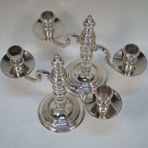 A handsome Sterling silver pair of George I style three-light candelabra, having plain round baluster bodies, fixed arms with drip pans, and central finial that can be pulled out to uncover the third candle holder. Made by Robert Comyns of London in 1937. The dimensions of this fine hand-made pair of silver candelabra are height 20 cms (8 inches), spread across arms 23 cms (9 inches), and with a total weight of approx. 809g (26 troy ounces). Please note that these candelabra are not filled.

   