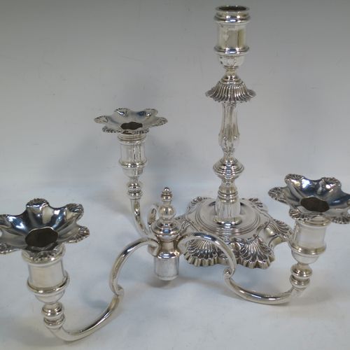 A handsome Sterling Silver cast single candelabrum in a George II style six-shell style, having removable three-light scroll arms with nozzles, and a central finial. Made in Birmingham in 1971. The dimensions of this fine hand-made silver three-light candelabrum are height 29 cms (11.5 inches), spread across arms 27 cms (10.75 inches), and with a total weight of approx. 1,300g (42 troy ounces). Please note that this candelabrum is all cast and not filled, so the whole weight is silver.   