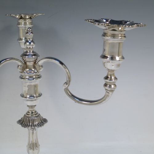 A handsome Sterling Silver cast single candelabrum in a George II style six-shell style, having removable three-light scroll arms with nozzles, and a central finial. Made in Birmingham in 1971. The dimensions of this fine hand-made silver three-light candelabrum are height 29 cms (11.5 inches), spread across arms 27 cms (10.75 inches), and with a total weight of approx. 1,300g (42 troy ounces). Please note that this candelabrum is all cast and not filled, so the whole weight is silver.   