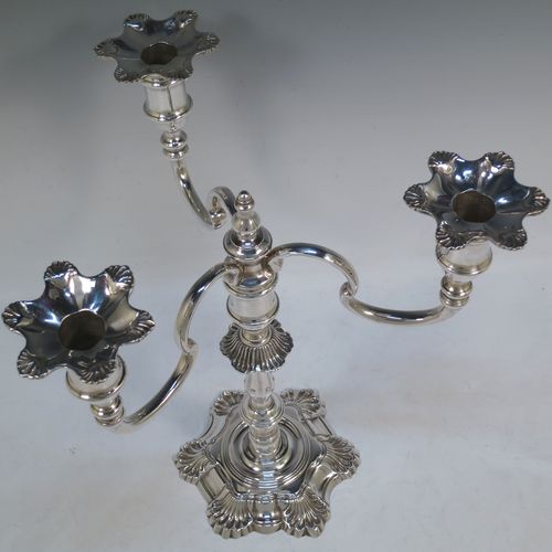 A handsome Sterling Silver cast single candelabrum in a George II style six-shell style, having removable three-light scroll arms with nozzles, and a central finial. Made in Birmingham in 1971. The dimensions of this fine hand-made silver three-light candelabrum are height 29 cms (11.5 inches), spread across arms 27 cms (10.75 inches), and with a total weight of approx. 1,300g (42 troy ounces). Please note that this candelabrum is all cast and not filled, so the whole weight is silver.   