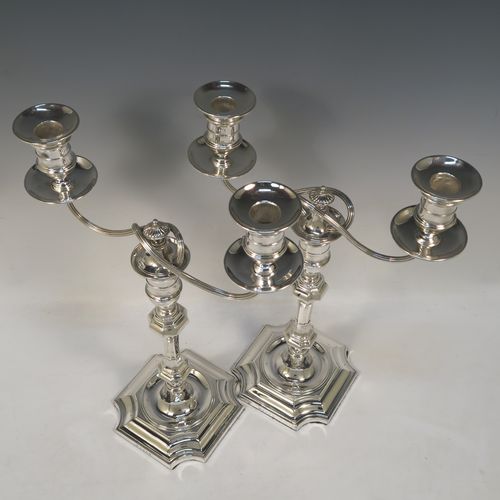 A very handsome pair of Antique Victorian two-light Silver Plated Georgian style candelabra, having cut-corner square bases, panelled baluster columns, with removable swirl and reeded arms, and matching capitals with drip pans and removable nozzles. Made by Elkington and Co., with a date letter for 1896. The dimensions of this fine hand-made pair silver-plated Georgian style  candelabra are height 35 cms (13.75 inches), and spread across arms 25 cms (10 inches).  