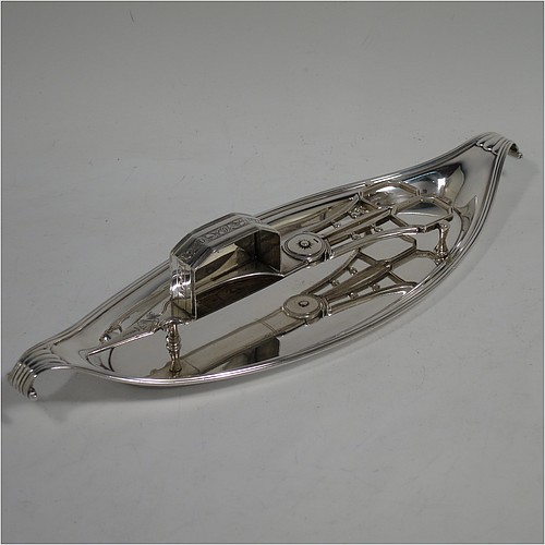 A very handsome Antique Georgian Sterling Silver candle scissor snuffer and stand, in a neoclassical style with applied reed-edged borders, and an oval boat-shaped stand. Made by Walter Brind of London in 1800. The dimensions of this fine hand-made antique silver scissor snuffer and stand are length 26 cms (10.25 inches), width 9 cms (3.5 inches), and they weigh a total of approx. 208g (6.7 troy ounces). 