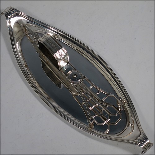 A very handsome Antique Georgian Sterling Silver candle scissor snuffer and stand, in a neoclassical style with applied reed-edged borders, and an oval boat-shaped stand. Made by Walter Brind of London in 1800. The dimensions of this fine hand-made antique silver scissor snuffer and stand are length 26 cms (10.25 inches), width 9 cms (3.5 inches), and they weigh a total of approx. 208g (6.7 troy ounces). 