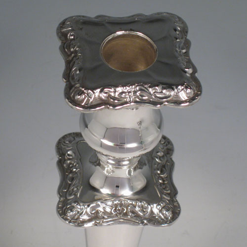 Sterling silver pair of baluster style candlesticks with shaped square bases and having chased floral decoration. Made by Emile Viner of Sheffield in 1935. Please note that these candlesticks have matching silver-plated removable nozzles, which is reflected in the price. The dimensions of this fine pair of hand-made silver candlesticks are height 28 cms (11 inches), and width at base 15 cms (6 inches).