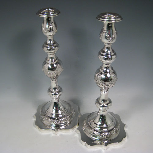 A very pretty Sterling Silver pair of Sabbath candlesticks, having round baluster bodies with hand-chased floral decoration, shaped square bases, and removable nozzles. Made by Morris Solovitch of London in 1921. The dimensions of these fine hand-made silver Sabbath candlesticks are height 32 cms (12.5 inches), base 13 cms (5 inches) square, and they weigh a total of approx. 696g (22.5 troy ounces). Please note that these candlesticks are not filled.