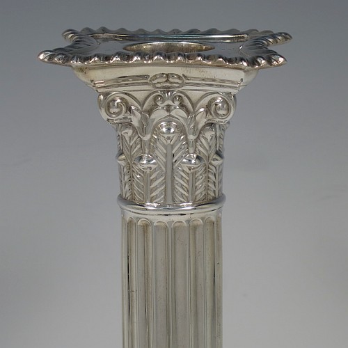 A very handsome set of four Sterling Silver table candlesticks, in a Neoclassical Corinthian style having square stepped bases, fluted columns, acanthus leaf capitals, removable nozzles, and gadroon borders. Made by D and J Welby of London in 1936. The dimensions of this fine hand-made set of four silver candlesticks are height 26 cms (10.25 inches), and their bases are 10 cms (4 inches) square.   