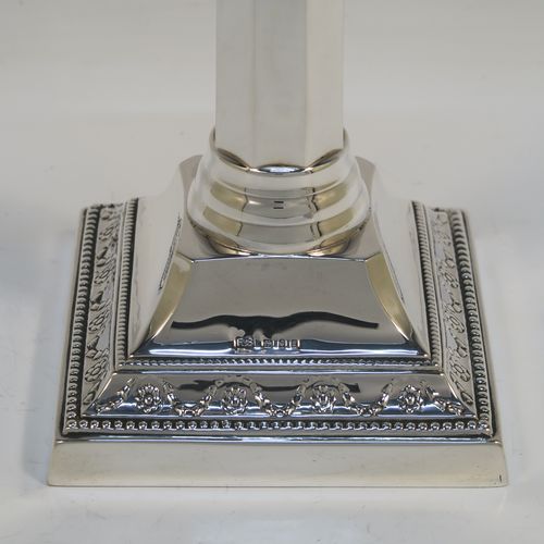 An elegant pair of Sterling Silver table candlesticks, in a Neoclassical Corinthian style having square bases with hand-chased swags, and bead-edged borders, with plain hexagonal columns, and original removable nozzles. This beautiful pair of silver candlesticks were made by R.S of of London in 1940. The dimensions of this fine hand-made pair silver candlesticks are height 29 cms (11.5 inches), and their bases are 10 cms (4 inches) square, and they weigh a total of 683g (22 troy ounces). Please note that these candlesticks are not loaded, so the whole weight is silver.   