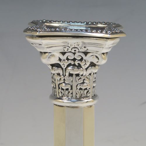 An elegant pair of Sterling Silver table candlesticks, in a Neoclassical Corinthian style having square bases with hand-chased swags, and bead-edged borders, with plain hexagonal columns, and original removable nozzles. This beautiful pair of silver candlesticks were made by R.S of of London in 1940. The dimensions of this fine hand-made pair silver candlesticks are height 29 cms (11.5 inches), and their bases are 10 cms (4 inches) square, and they weigh a total of 683g (22 troy ounces). Please note that these candlesticks are not loaded, so the whole weight is silver.   