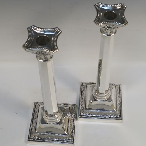 An elegant pair of Sterling Silver table candlesticks, in a Neoclassical Corinthian style having square bases with hand-chased swags, and bead-edged borders, with plain hexagonal columns, and original removable nozzles. This beautiful pair of silver candlesticks were made by R.S of of London in 1940. The dimensions of this fine hand-made pair silver candlesticks are height 29 cms (11.5 inches), and their bases are 10 cms (4 inches) square, and they weigh a total of 683g (22 troy ounces). Please note that these candlesticks are not loaded, so the whole weight is silver.   