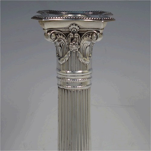 A very pretty pair of Sterling Silver table candlesticks, in a Neoclassical Corinthian style having square stepped bases, fluted columns, swag style capitals, removable nozzles, and bead-edged borders. Made by Mappin and Webb of London in 1935, and Sheffield in 1928. The dimensions of this fine hand-made pair of silver candlesticks are height 26 cms (10.25 inches), and their bases are 11.5 cms (4.5 inches) square.    