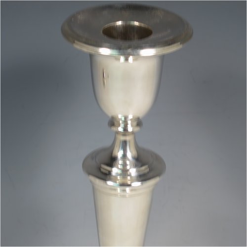 An Antique Victorian Sterling Silver set of four large table candlesticks, in a plain round style, having round bodies with hand-chased reeded borders, tapering columns, and removable nozzles. Made by Elkington & Co., of Sheffield in 1899. The dimensions of these fine hand-made antique silver candlesticks are height 29 cms (11.5 inches), and diameter at bases 14 cms (5.5 inches).   