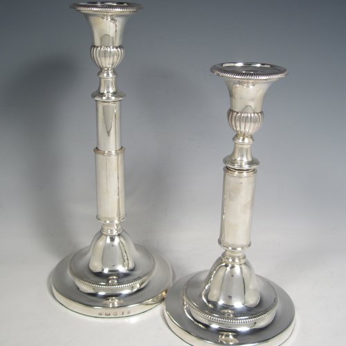 Antique Georgian sterling silver pair of rare telescopic candlesticks, having round baluster bases and plain straight-sided collumns, with gadroon borders, and removable nozzles. Made by George Ashford & Co., of Sheffield in 1804. The dimensions of these fine hand-made silver candlesticks are height 25 cms (9.75 inches), and when extended 30 cms (11.75 inches), and base 13.5 cms (5.25 inches) diameter. 