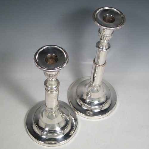 Antique Georgian sterling silver pair of rare telescopic candlesticks, having round baluster bases and plain straight-sided collumns, with gadroon borders, and removable nozzles. Made by George Ashford & Co., of Sheffield in 1804. The dimensions of these fine hand-made silver candlesticks are height 25 cms (9.75 inches), and when extended 30 cms (11.75 inches), and base 13.5 cms (5.25 inches) diameter. 