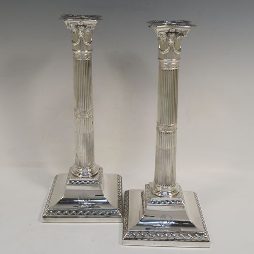 A very pretty pair of Antique Georgian Sterling Silver table candlesticks, in a Neoclassical Corinthian style having square bases with fluted columns, leaf tendril and double-bead border decoration, the capitals with swags and bead-work decoration on the removable nozzles. These beautiful antique silver candlesticks were made John Waterhouse of Sheffield in 1781. The dimensions of this fine hand-made pair of antique silver table candlesticks are height 29 cms (11.5 inches), and their bases are 12 cms (4.75 inches) square. Please note that these items are crested on the bases.