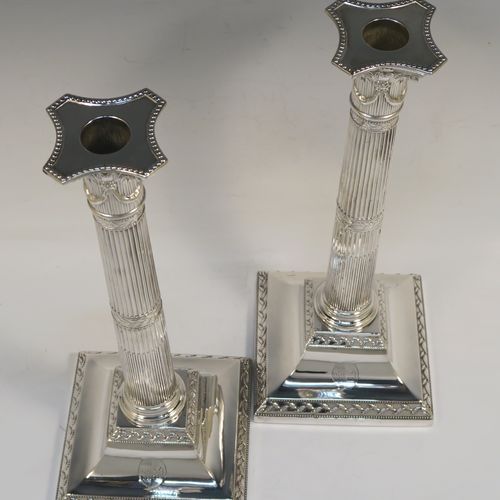 A very pretty pair of Antique Georgian Sterling Silver table candlesticks, in a Neoclassical Corinthian style having square bases with fluted columns, leaf tendril and double-bead border decoration, the capitals with swags and bead-work decoration on the removable nozzles. These beautiful antique silver candlesticks were made John Waterhouse of Sheffield in 1781. The dimensions of this fine hand-made pair of antique silver table candlesticks are height 29 cms (11.5 inches), and their bases are 12 cms (4.75 inches) square. Please note that these items are crested on the bases.