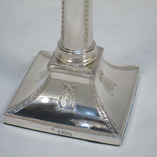 A very pretty set of four Antique Victorian Sterling Silver table candlesticks, in a Neoclassical Corinthian style having square bases with swags, ribbon and bows, and bead-work decoration, and removable nozzles. Made by Thomas Bradbury of London in 1896/97. The dimensions of this fine hand-made set of four antique silver candlesticks are height 23.5 cms (9.25 inches), and their bases are 11 cms (4.25 inches) square.   