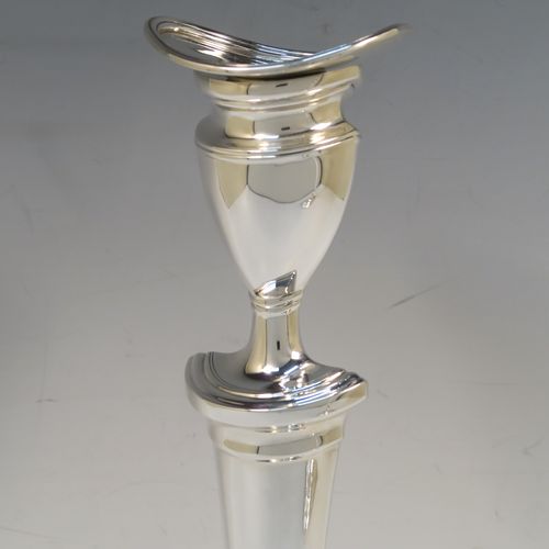 A very handsome pair of Antique Edwardian Sterling Silver candlesticks, having neoclassical plain oval boat-shaped bodies with reeded borders and tapering columns, and original removable nozzles. These elegant antique silver candlesticks were made by Thomas Bradbury of Sheffield in 1903. The dimensions of these fine hand-made antique silver candlesticks are height 30.5 cms (12 inches), and the bases are 17 cms (6.75 inches) long.   