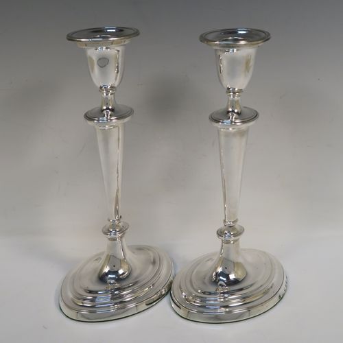 A very handsome pair of Antique Georgian Sterling Silver candlesticks, having neoclassical plain oval boat-shaped bodies with reeded borders and tapering columns, and original removable nozzles. These elegant antique silver candlesticks were made by Joseph Shemell of Sheffield in 1799. The dimensions of these fine hand-made antique silver candlesticks are height 26 cms (10.25 inches), and the bases are 14 cms (5.5 inches) long.   