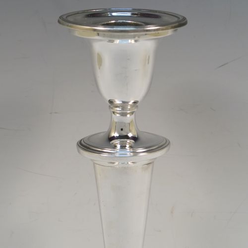 A very handsome pair of Antique Georgian Sterling Silver candlesticks, having neoclassical plain oval boat-shaped bodies with reeded borders and tapering columns, and original removable nozzles. These elegant antique silver candlesticks were made by Joseph Shemell of Sheffield in 1799. The dimensions of these fine hand-made antique silver candlesticks are height 26 cms (10.25 inches), and the bases are 14 cms (5.5 inches) long.   