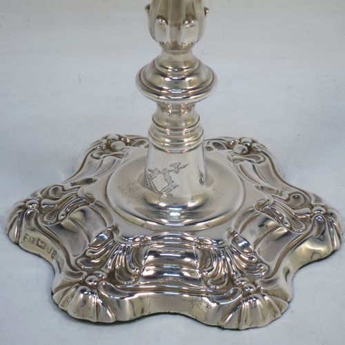 A handsome pair of Antique Georgian Sterling Silver George IV candlesticks, having round baluster bodies, with six-shell bases, and removable nozzles. Made by Kirby Westerhouse and Co., of Sheffield in 1828. The dimensions of this fine pair of hand-made antique silver candlesticks are height 23 cms (9 inches), and width at base 14 cms (5.5 inches). Please note that these candlesticks are filled, not cast.  