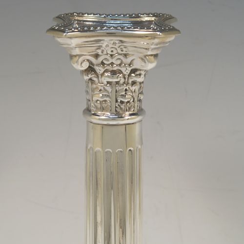 A very handsome and bold pair of Sterling Silver Corinthian style candlesticks, having traditional bead borders, acanthus-leaf capitals, fluted columns, removable nozzles, and square stepped bases. These beautiful silver candlesticks were made by Robert Spencer of London in 1947. The dimensions of this fine hand-made pair of silver candlesticks are height 27 cms (10.5 inches), the bases are 10 cms (4 inches) square, and they weigh a total of 683g (22 troy ounces). Please note that these candlesticks are not weighted so the whole weight is silver.  