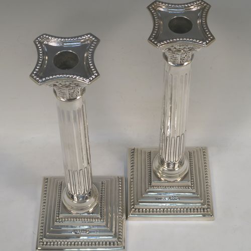 A very handsome and bold pair of Sterling Silver Corinthian style candlesticks, having traditional bead borders, acanthus-leaf capitals, fluted columns, removable nozzles, and square stepped bases. These beautiful silver candlesticks were made by Robert Spencer of London in 1947. The dimensions of this fine hand-made pair of silver candlesticks are height 27 cms (10.5 inches), the bases are 10 cms (4 inches) square, and they weigh a total of 683g (22 troy ounces). Please note that these candlesticks are not weighted so the whole weight is silver.  