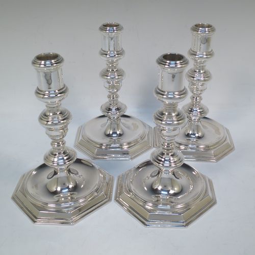 A very elegant set of four cast Sterling Silver candlesticks in a George I style, having plain round baluster bodies, and sitting on plain octagonal bases. Made by Goldsmiths and Silversmiths of Sheffield in 1931. The dimensions of this fine set of hand-made silver table candlesticks are height 19 cms (7.5 inches), the bases are 12.5 cms (5 inches) square, and the total weight is 1,602g (52 troy ounces)  