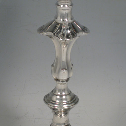 Antique Georgian George II cast sterling silver pair of candlesticks, having baluster bodies, four-shell bases, and removable nozzles. Made by John Cafe of London in 1754. Height 20.5 cms (8 inches). Total weight 889g (28.7 troy ounces).
