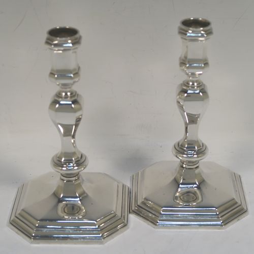 A very elegant pair of cast Sterling Silver candlesticks in a George I style, having plain octagonal panelled baluster bodies. These handsome cast silver candlesticks were made by Bryan Savage of London in 1975. The dimensions of this fine pair of hand-made cast silver table candlesticks are height 15 cms (6 inches), the bases are 10 cms (4 inches) square, and the total weight is 772g (25 troy ounces).