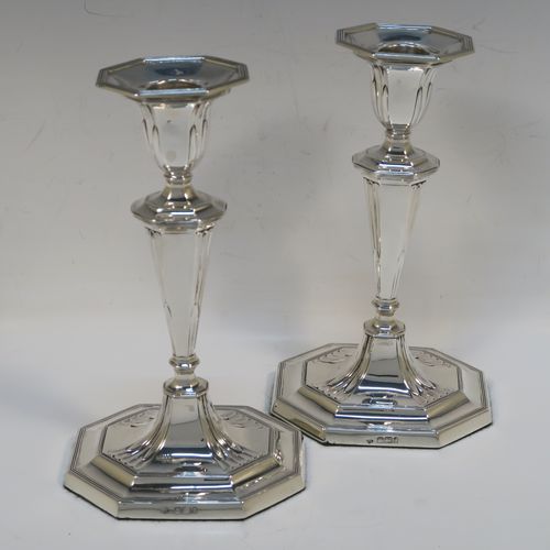 A very elegant Antique Victorian Sterling Silver pair of candlesticks, having octagonal bodies with hand-chased fluted decoration, reed-edged borders, and removable nozzles. These handsome antique silver candlesticks were made by Martin & Hall of Sheffield in 1901. The dimensions of these fine hand-made antique silver candlesticks are height 18.5 cms (7.25 inches), and the bases are 10 cms (4 inches) long, by 8 cms (3 inches) wide.   