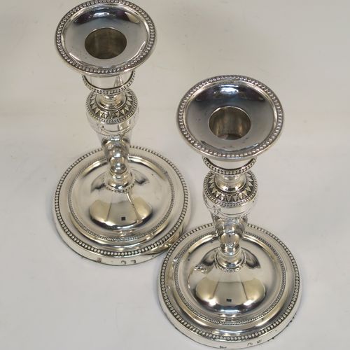 A very pretty pair of Antique Georgian Sterling Silver candlesticks in a neoclassical style, having tapering columns and round bases, with removable original nozzles, hand-chased neoclassical swag style decoration and bead-edged borders. These beautiful antique silver candlesticks were made by Daniel Smith and Robert Sharp of Sheffield in 1782/3. The dimensions of these fine hand-made antique silver candlesticks are height 16.5 cms (6.5 inches), and the bases are 9 cms (3.5 inches) diameter.   