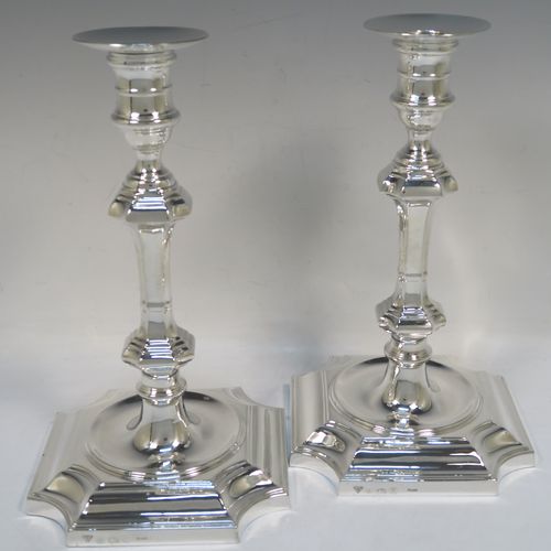 A handsome and bold pair of Sterling Silver candlesticks in a George I style, having octagonal baluster bodies, with round removable round nozzles, and sitting on cut-corner square bases. These elegant silver candlesticks were made by Garrard and Co., of Birmingham in 1984. The dimensions of these fine hand-made silver table candlesticks are height 24 cms (9.5 inches), and the bases are 14 cms (5.5 inches) square.   