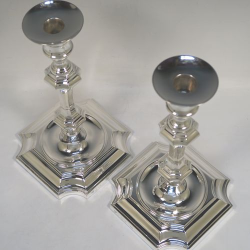 A handsome and bold pair of Sterling Silver candlesticks in a George I style, having octagonal baluster bodies, with round removable round nozzles, and sitting on cut-corner square bases. These elegant silver candlesticks were made by Garrard and Co., of Birmingham in 1984. The dimensions of these fine hand-made silver table candlesticks are height 24 cms (9.5 inches), and the bases are 14 cms (5.5 inches) square.   