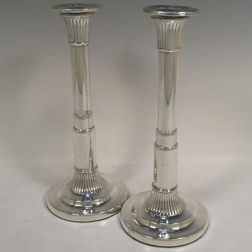 A very handsome and rare pair of Antique Georgian Sterling Silver telescopic candlesticks, having round straight-sided columns, with fluted decoration round the tops and bases, and removable nozzles. These elegant antique silver telescopic candlesticks were made by George Ashfoed and Co., of Sheffield in 1800. The dimensions of these fine hand-made antique silver telescopic candlesticks are height collapsed 18 cms (5 inches), extended 27 cms (10.5 inches), and the diameter of the bases are 11.5 cms (4.5 inches). Please note that these items are part crested. 