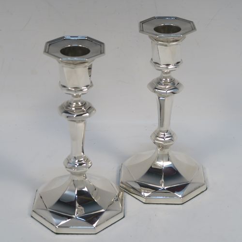 A very elegant Antique Sterling Silver pair of candlesticks, having octagonal panelled bodies, with reed-edged borders, and removable nozzles. These handsome antique silver candlesticks were made by Hawksworth and Eyers of Sheffield in 1920. The dimensions of these fine hand-made antique silver candlesticks are height 15 cms (6 inches), and the bases are 8.5 cms (3.3 inches) at their widest point.  