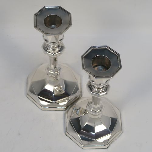 A very elegant Antique Sterling Silver pair of candlesticks, having octagonal panelled bodies, with reed-edged borders, and removable nozzles. These handsome antique silver candlesticks were made by Hawksworth and Eyers of Sheffield in 1920. The dimensions of these fine hand-made antique silver candlesticks are height 15 cms (6 inches), and the bases are 8.5 cms (3.3 inches) at their widest point.  