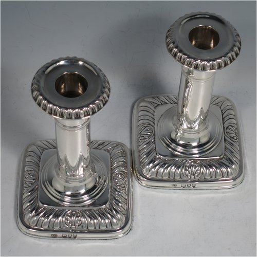 An Antique Victorian Sterling Silver pair of candlesticks, in a Georgian Regency style with plain round columns on square bases with rounded corners, gadroon edged borders, and removable nozzles. Made by Matthew John Jessop of London in 1895. The dimensions of this fine pair of hand-made silver candlesticks are height 14 cms (5.5 inches), and the bases are 9 cms (3.5 inches) square.